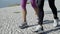 Legs of active retired joggers running on promenade