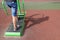 Legs of amateur athlete on street treadmill, with shadow on the surface of the sports ground