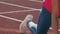 Legs of an athlete athlete who warms up before the start bouncing on the treadmill.