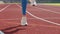 Legs of an athlete athlete who warms up before the start bouncing on the treadmill.