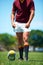 Legs, athlete and player with rugby ball for sports workout or training on a field. Feet, fitness and man ready for