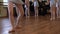 Legs of balerinas who do exercises during ballet lesson in ballet classroom