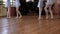 Legs of balerinas who do exercises in pairs during ballet lesson.