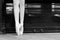 Legs of a ballerina in pointe shoes against the background of an old piano. Close-up. Black and white photo. Classical dances