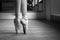 Legs of a ballerina in pointes. Close-up. Black and white photo. Classical dances