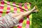 Legs of a beautiful young woman in summer dress on colorful picnic blanket