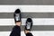 Legs in black sneakers at the zebra crossing,