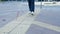 Legs of blind person searching special tactile tiles using cane. Blind man walking with a cane in the street