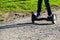 Legs of boy riding on self-balancing mini hoverboard in the city park