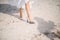 The legs of the bride in a wedding dress in shoes