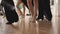 Legs of Caucasian boys and girl dancing latin ballroom dance in studio. Unrecognizable group of confident children