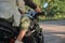 Legs close up Middle age couple riding a motorcycle, traveling together on a forest road