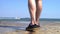 Legs closeup, Sea seafront breakwater concept, casual legs of young man walking through the pier, boat riding cross