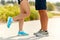 Legs of couple of sportsmen in sneakers outdoors