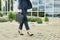 Legs detail of business woman on the way to office, walking outdoors holding a laptop case, wearing business suit and