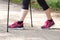 Legs of elderly senior woman practicing nordic walking, sporty lifestyles in old age