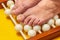 Legs of an elderly woman on a roller massager close up. Foot massage concept for wellness and proper blood circulation