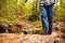 Legs and feet of boy balancing on a fallen tree in a forest