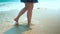 Legs feet caucasian girl walking barefoot wet sand island beach. Close Up Shot.