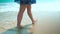 Legs feet caucasian girl walking barefoot wet sand island beach. Slow Motion. Close Up Shot.