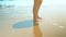 Legs feet caucasian girl walking barefoot wet sand island beach. Slow Motion. Close Up Shot.