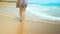 Legs feet caucasian girl walking barefoot wet sand island beach. Slow Motion. Close Up Shot.