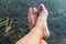 Legs and feet relaxing in front of serene fresh water pond