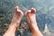 Legs and feet relaxing in front of serene fresh water pond