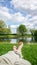 Legs and feet relaxing in front of serene water