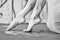 Legs and feet of a Young artistically abstract painted woman ballerina with white paint. Creative body art