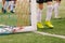 Legs of Football Players in Sports Cleats. Football Goal Post with Soccer Net