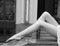 legs of girl on marble parapet. Black and white.