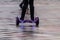 Legs of girl riding on self-balancing mini hoverboard in the city street