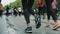 Legs of girls athletes in leggings running marathon in crowd