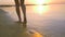 Legs girls go on the beach at sunset. HD