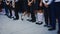 Legs of girls in white golf and boys in suit pants stand in line at the school track on September 1. September 1 - school line.