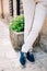 legs of the groom standing near the old house in Perast