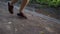 Legs of a jogger running in a park slow motion