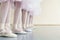 Legs of little ballerinas standing in fifth position