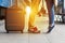 Legs Loving Couple happy hugging in the train station of a country after arrival with a warm sunlight background