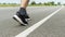 The legs of male athletes in black shoes are preparing to run on the paved road Outdoor exercise for weight loss and good health.