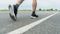 The legs of male athletes in black shoes are preparing to run on the paved road Outdoor exercise for weight loss and good health.