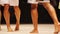 Legs of male fitness models posing at bodybuilding competition, healthy feet