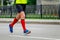 legs male runner athlete running marathon in city in red compression socks