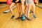 Legs of man and girls with balls in bowling club