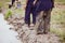 Legs in muddy of children standing beside the rice field