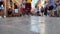 legs of people crowd of tourists walking on the island of Corfu central street in the city paved tiles on the ground