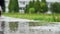 Legs of a runner in sneakers. Sports woman jogging outdoors, stepping into muddy puddle. Single runner running in rain