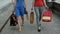 Legs slender young girls walking down the street past the store with shopping bags, slow mo stedicam shot