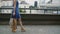 Legs slender young woman, walking in the city down the street with shopping bags, side view, slow mo, stedicam shot